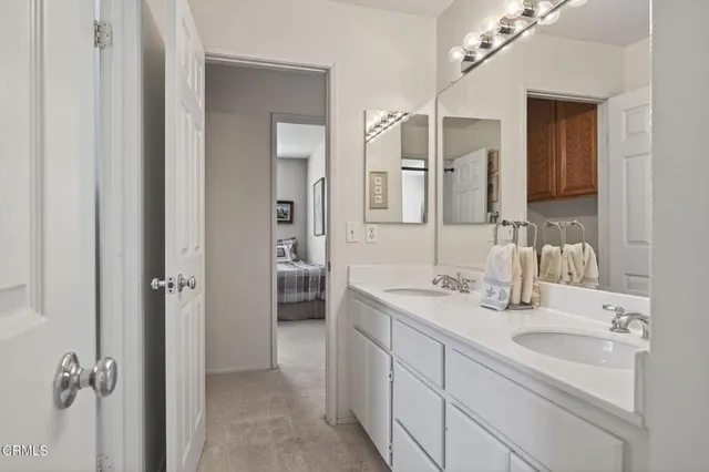 a en suite bathroom with double sink and a mirror