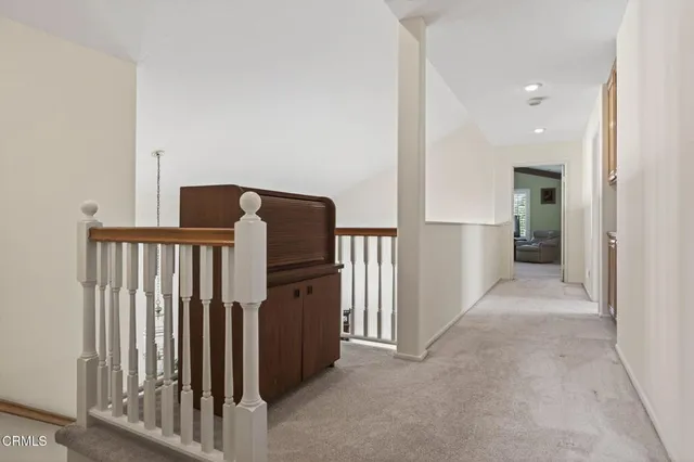 a living room with lots of furniture and a book shelf