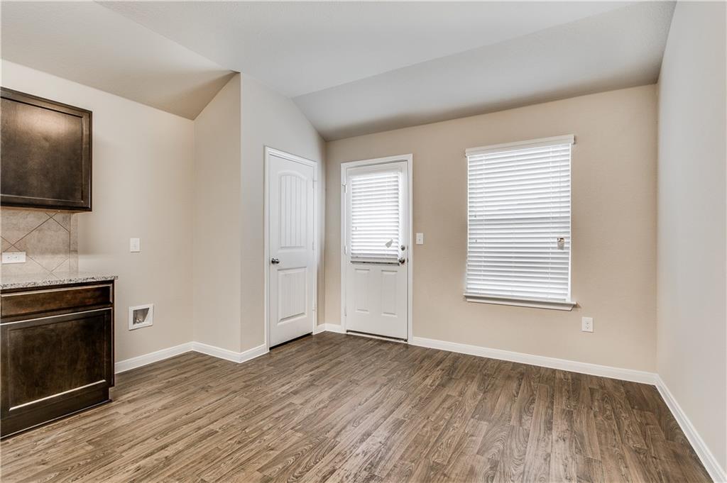 185 Voss Kyle, TX 78640 - Photo 8 of 26 a view of an empty room with a fireplace and a window
