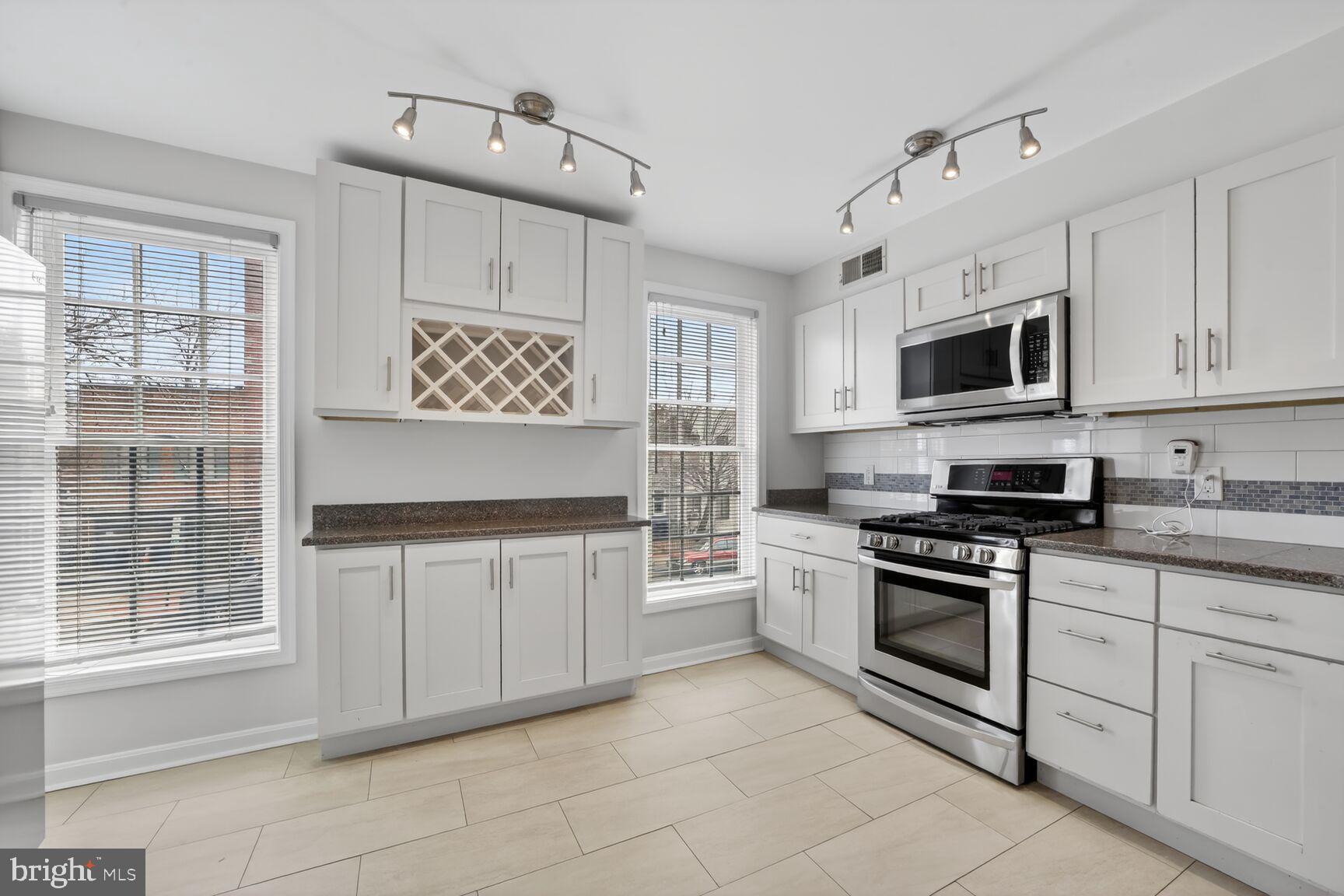 329 1/2 6th Street Southeast, Unit B Washington, DC 20003 - Photo 3 of 13 a kitchen with cabinets appliances and a window