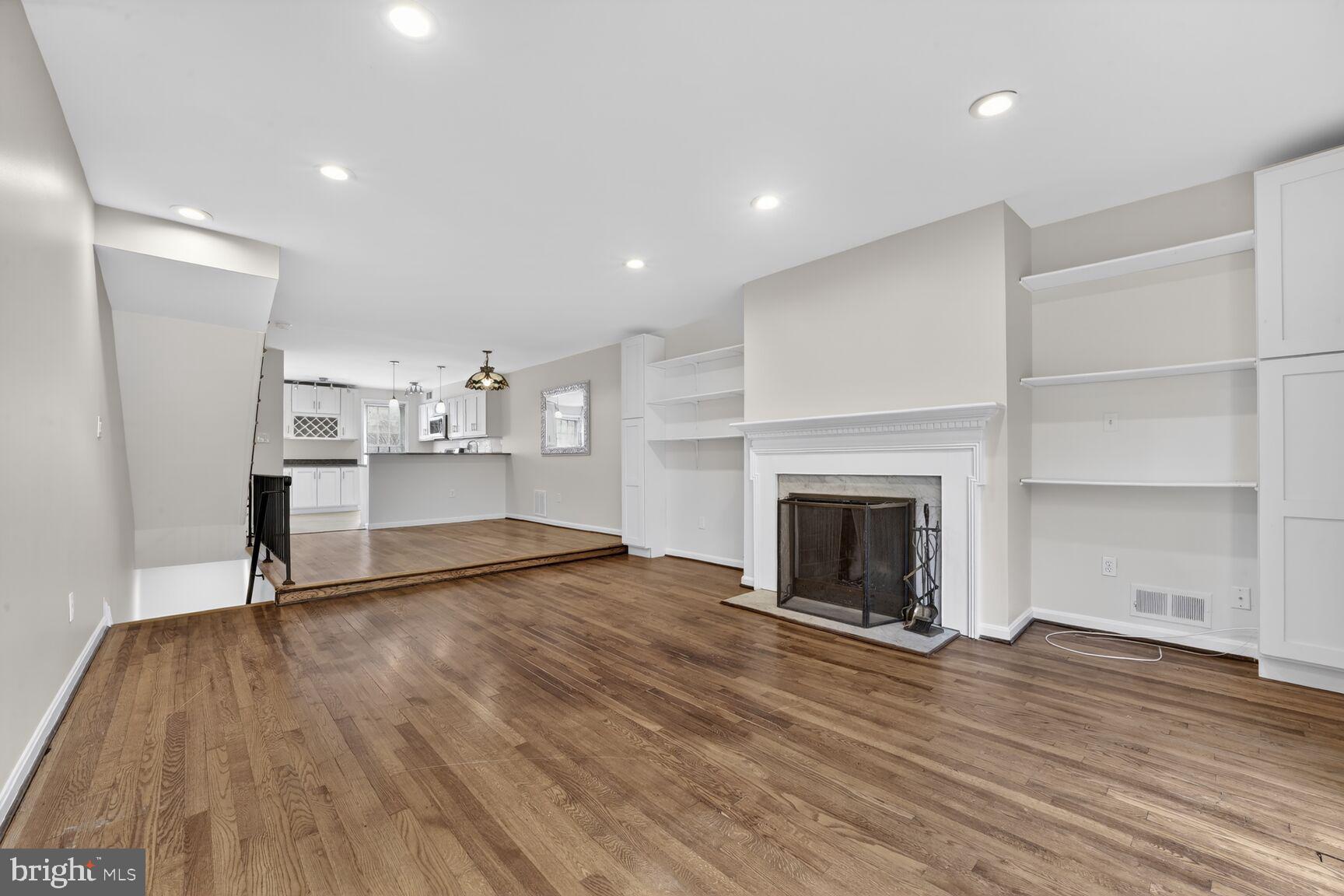 329 1/2 6th Street Southeast, Unit B Washington, DC 20003 - Photo 12 of 13 a view of empty room with wooden floor and fireplace