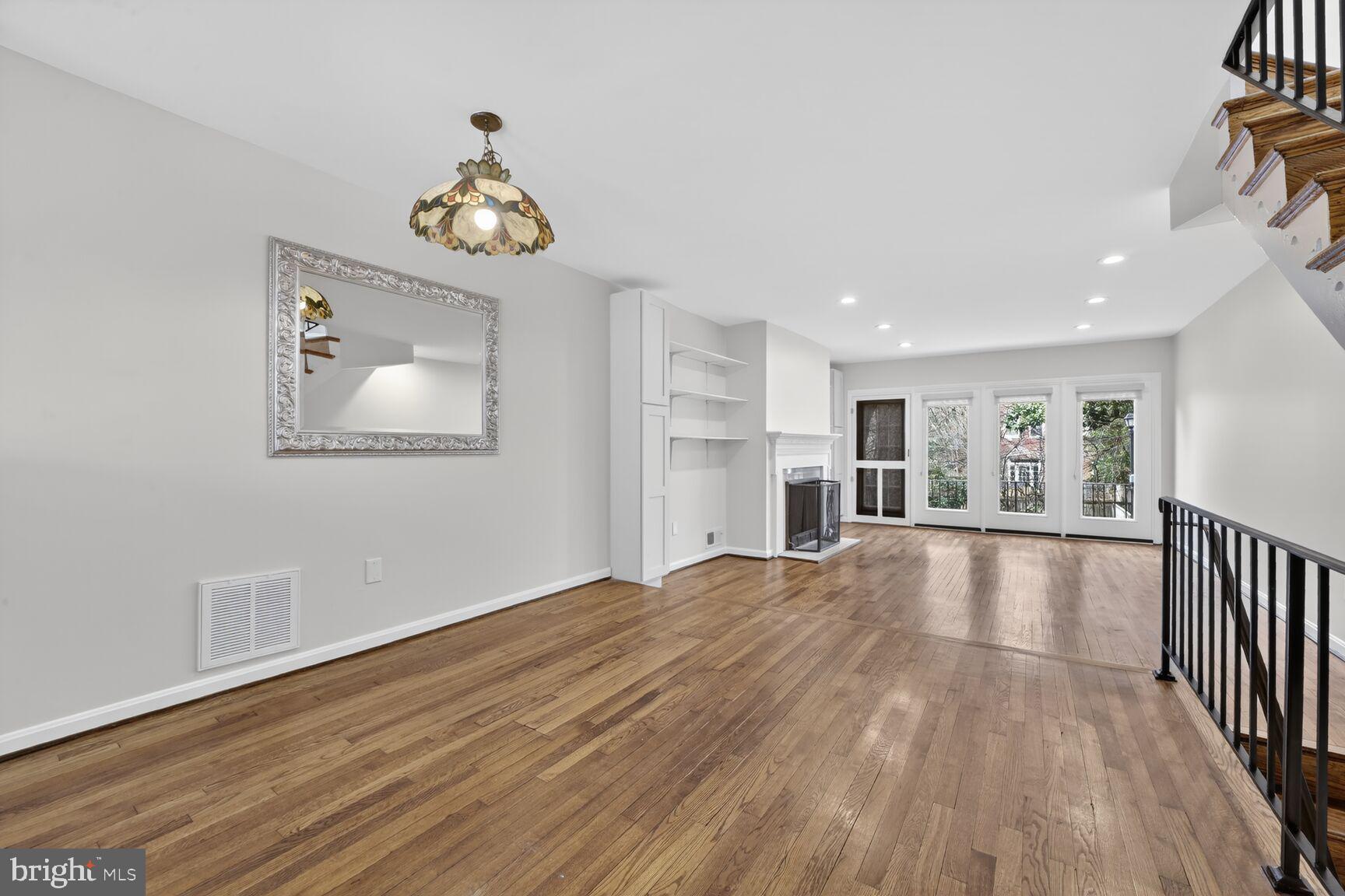 329 1/2 6th Street Southeast, Unit B Washington, DC 20003 - Photo 13 of 13 a view of an empty room with wooden floor and a window