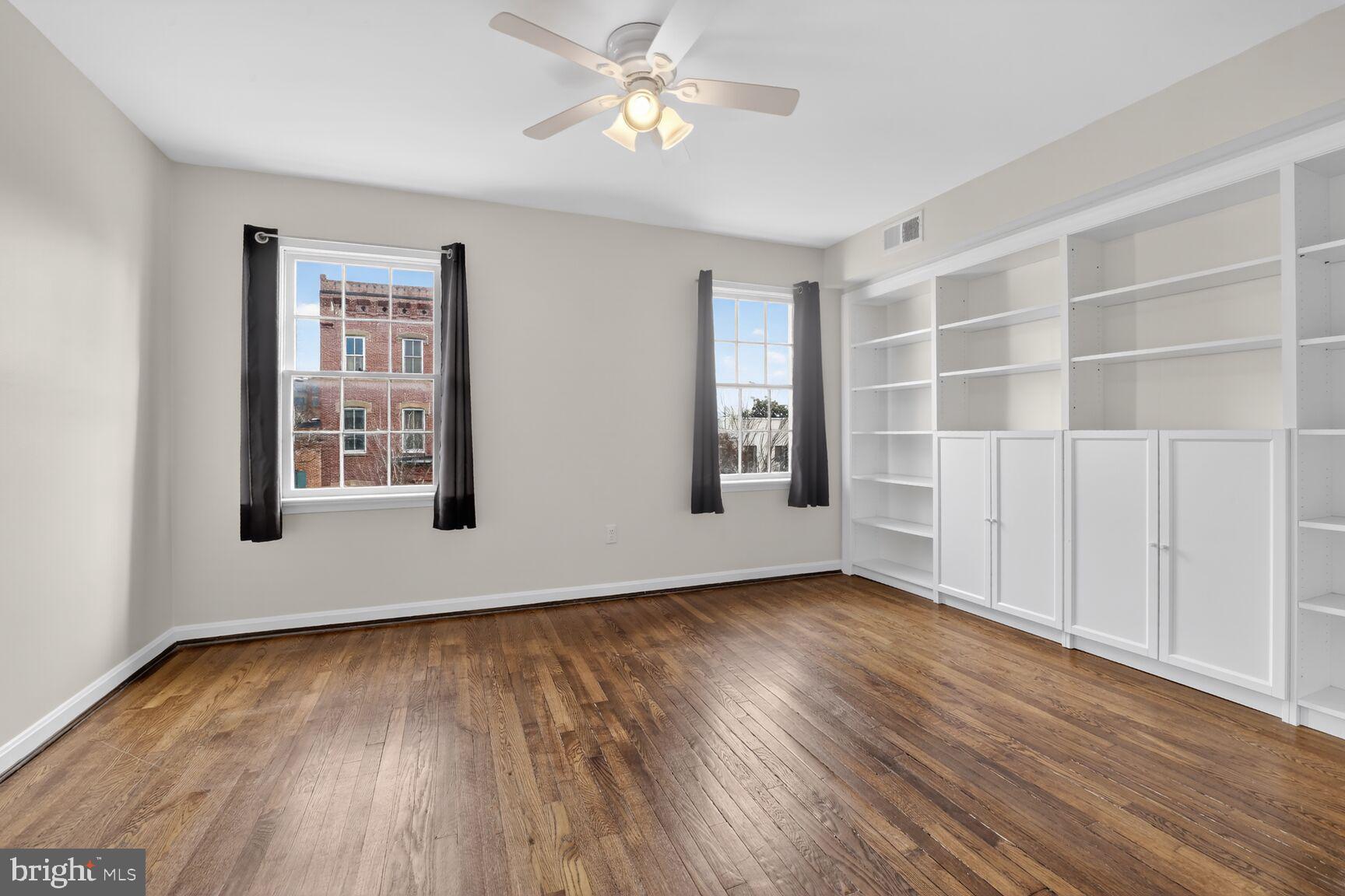 329 1/2 6th Street Southeast, Unit B Washington, DC 20003 - Photo 6 of 13 a view of an empty room with a window and wooden floor