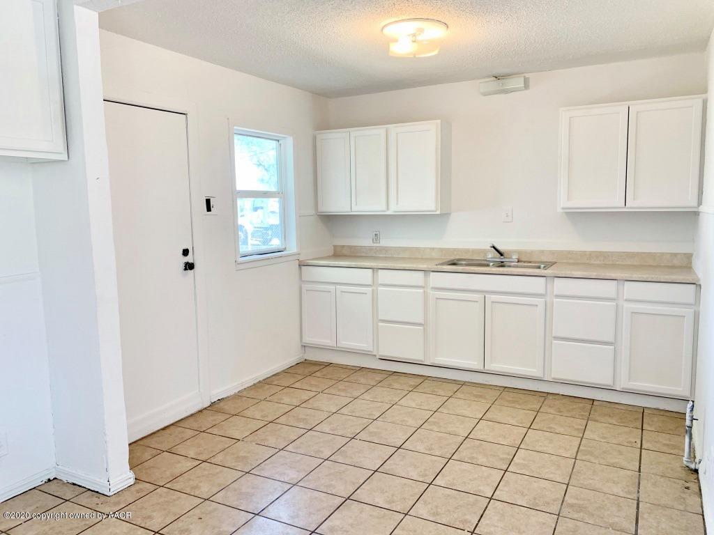4131 South Harrison Street Amarillo, TX 79110 - Photo 3 of 8 a kitchen with a stove a sink and cabinets