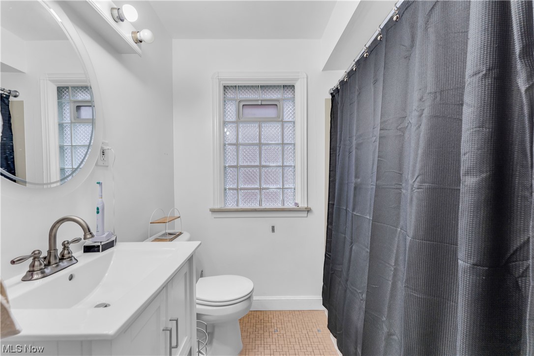 13566 Cedar Road Cleveland, OH 44118 - Photo 20 of 49 Bathroom featuring toilet, tile floors, and vanity with extensive cabinet space