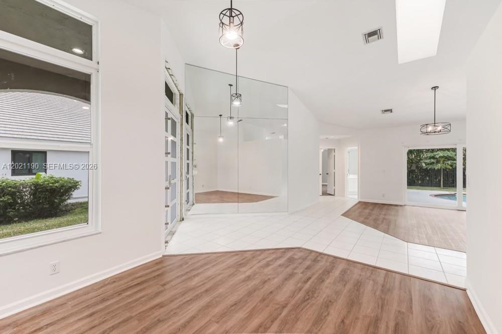 814 Heron Road Weston, FL 33326 - Photo 8 of 27 a view of a room with wooden floor and window
