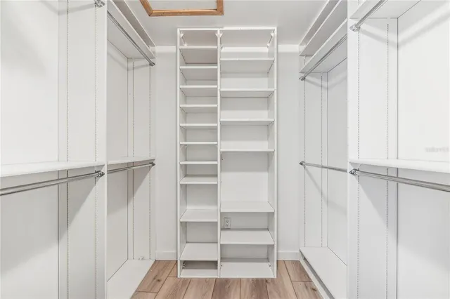 a view of walk in closet with empty racks