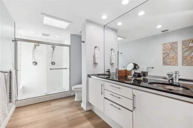 a kitchen with white cabinets and sink