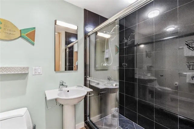a bathroom with a sink toilet and shower