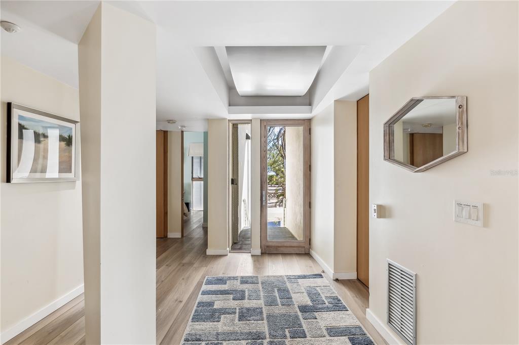 2925 Shore Lane Boca Grande, FL 33921 - Photo 3 of 25 a view of a hallway with wooden floor and a bathroom