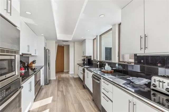 a kitchen with stainless steel appliances granite countertop a stove and a sink