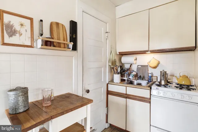a kitchen with a sink cabinets and appliances