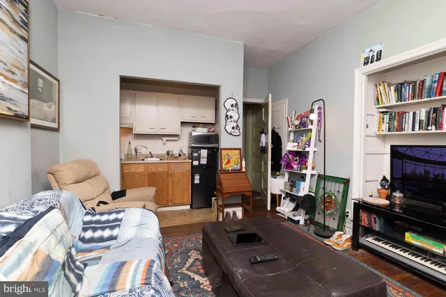 a living room with furniture and a book shelf