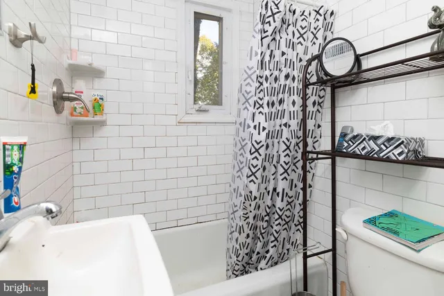a bathroom with a bathtub and shower
