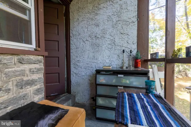 a living room with a rug bed and a window