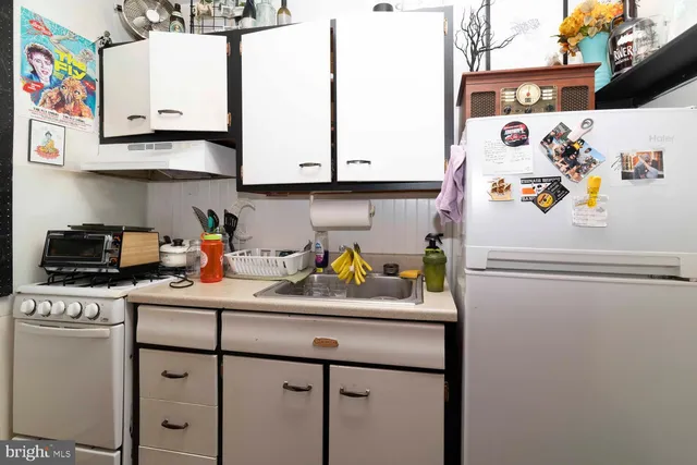 a kitchen with a refrigerator and a stove