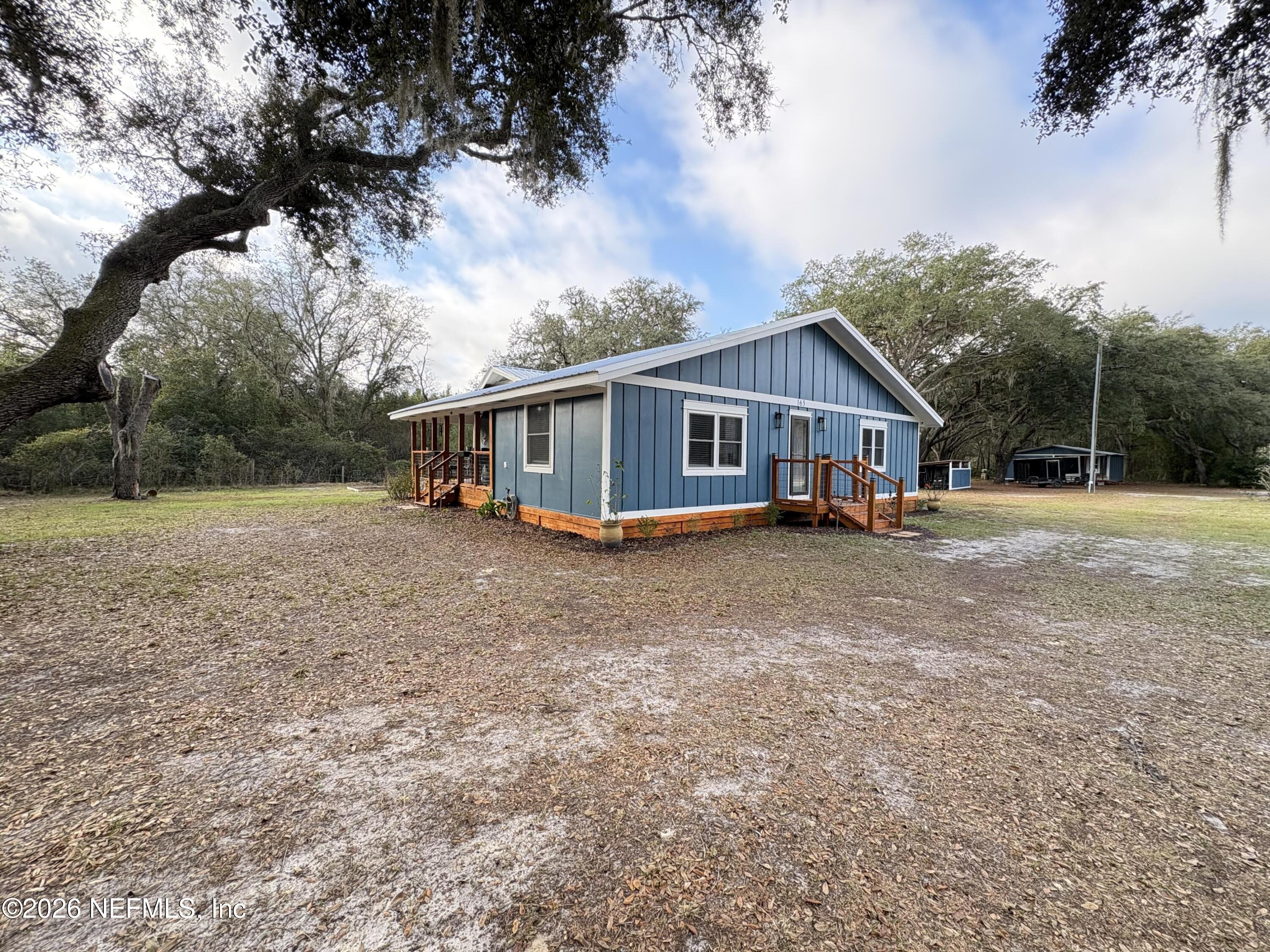 165 Fulton Road Palatka, FL 32177 - Photo 2 of 26 a view of house with a big yard and large trees