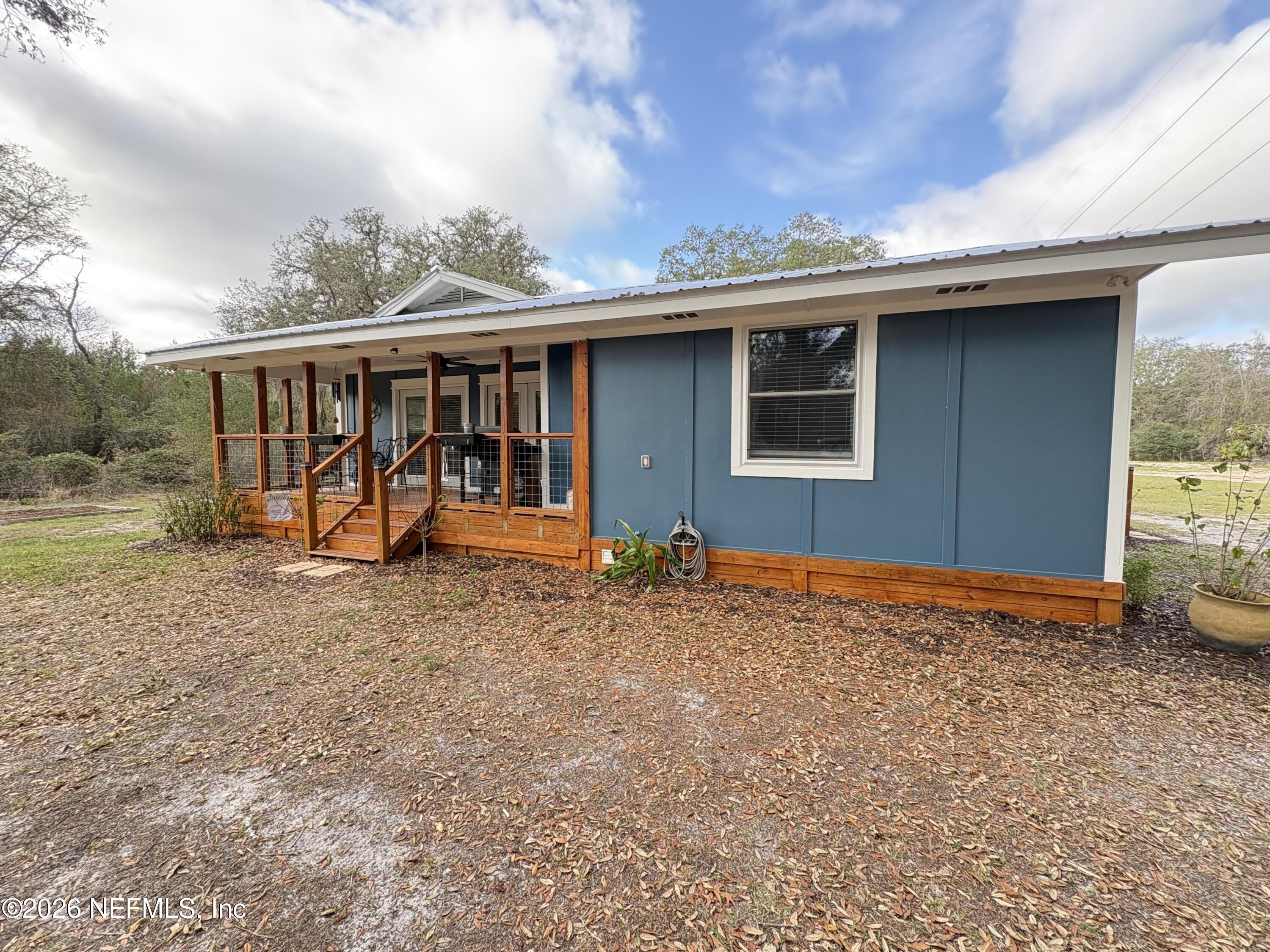 165 Fulton Road Palatka, FL 32177 - Photo 3 of 26 a backyard of a house with barbeque oven table and chairs