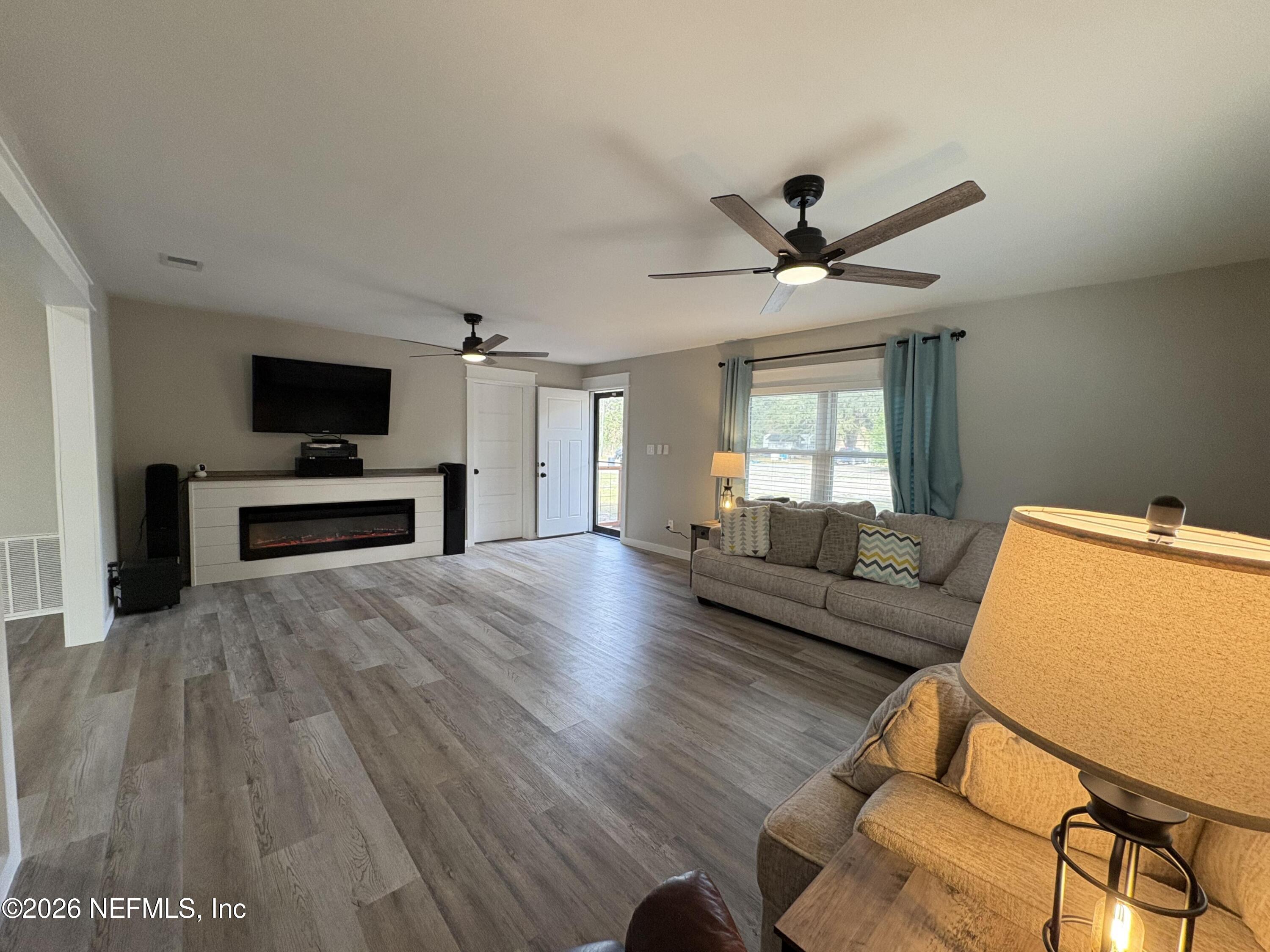 165 Fulton Road Palatka, FL 32177 - Photo 7 of 26 a living room with furniture and a flat screen tv
