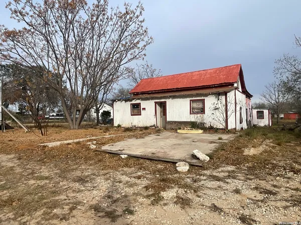 a house that has a tree in front of it