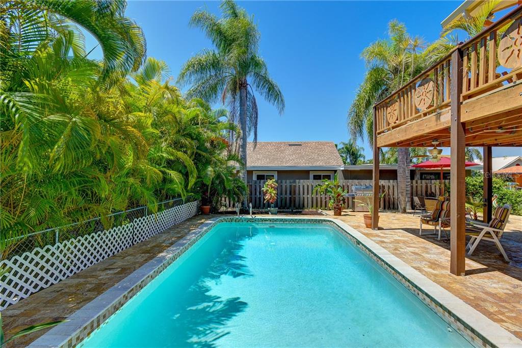 17608 Sterling Terrace Redington Shores, FL 33708 - Photo 1 of 1 Tropical oasis with large lap pool with covered area for shade and uncovered as well. Travertine tile patio makes for great entertaining.