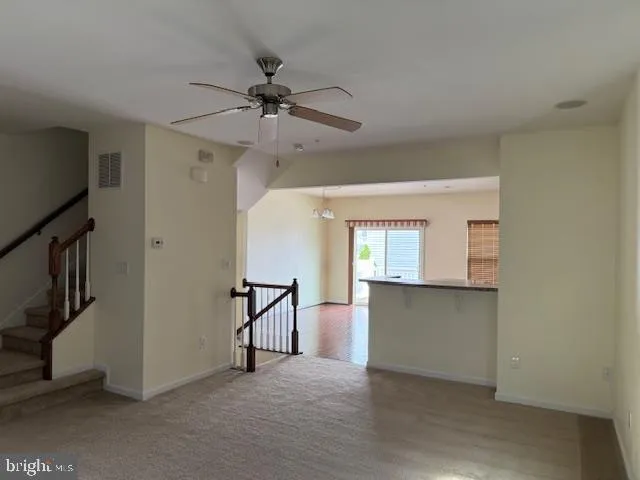 a kitchen with stainless steel appliances a refrigerator a stove a sink and white cabinets with wooden floor