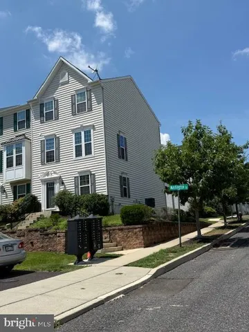 a view of a street with a cars parked in front of it