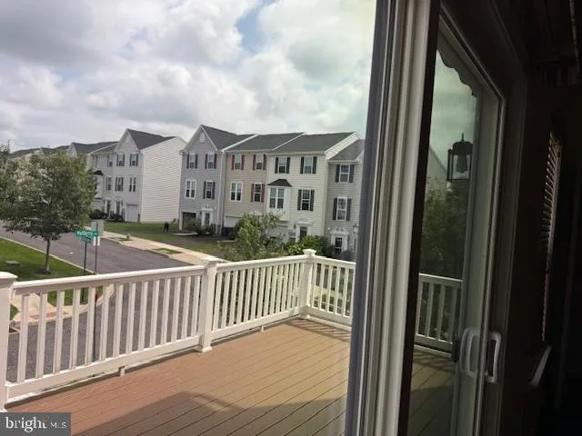 a view of a kitchen with cabinets and wooden floor