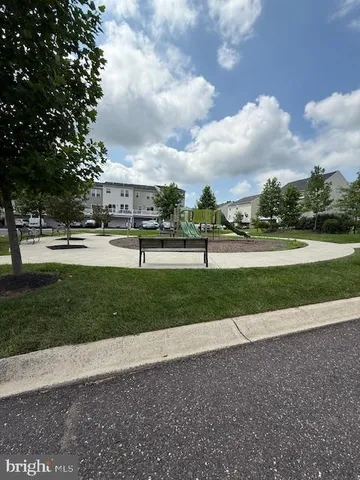 a view of swimming pool with outdoor seating and green space