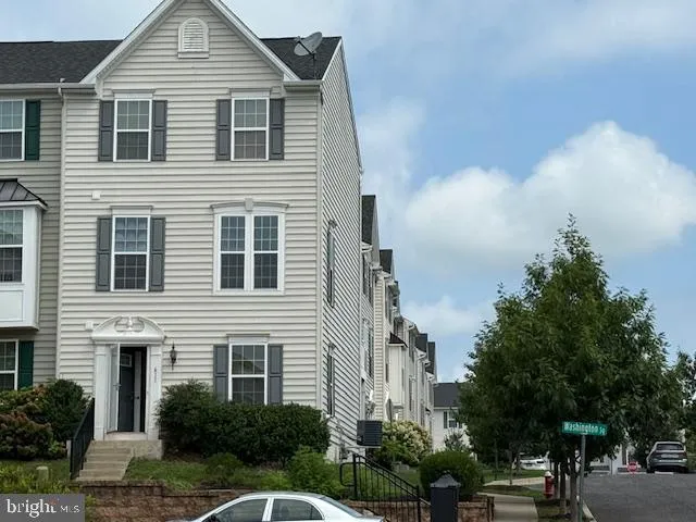 a yellow house with trees in front of it