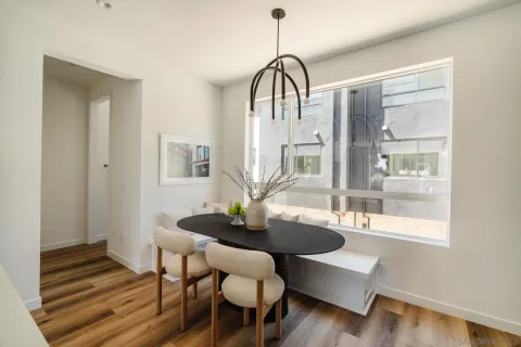 a dining room with furniture and wooden floor