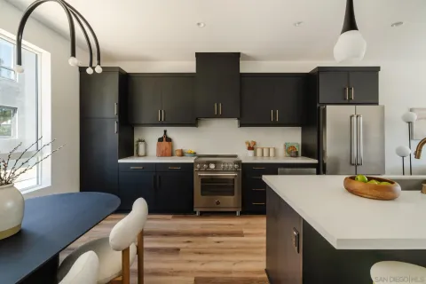 a kitchen with a refrigerator and a stove top oven