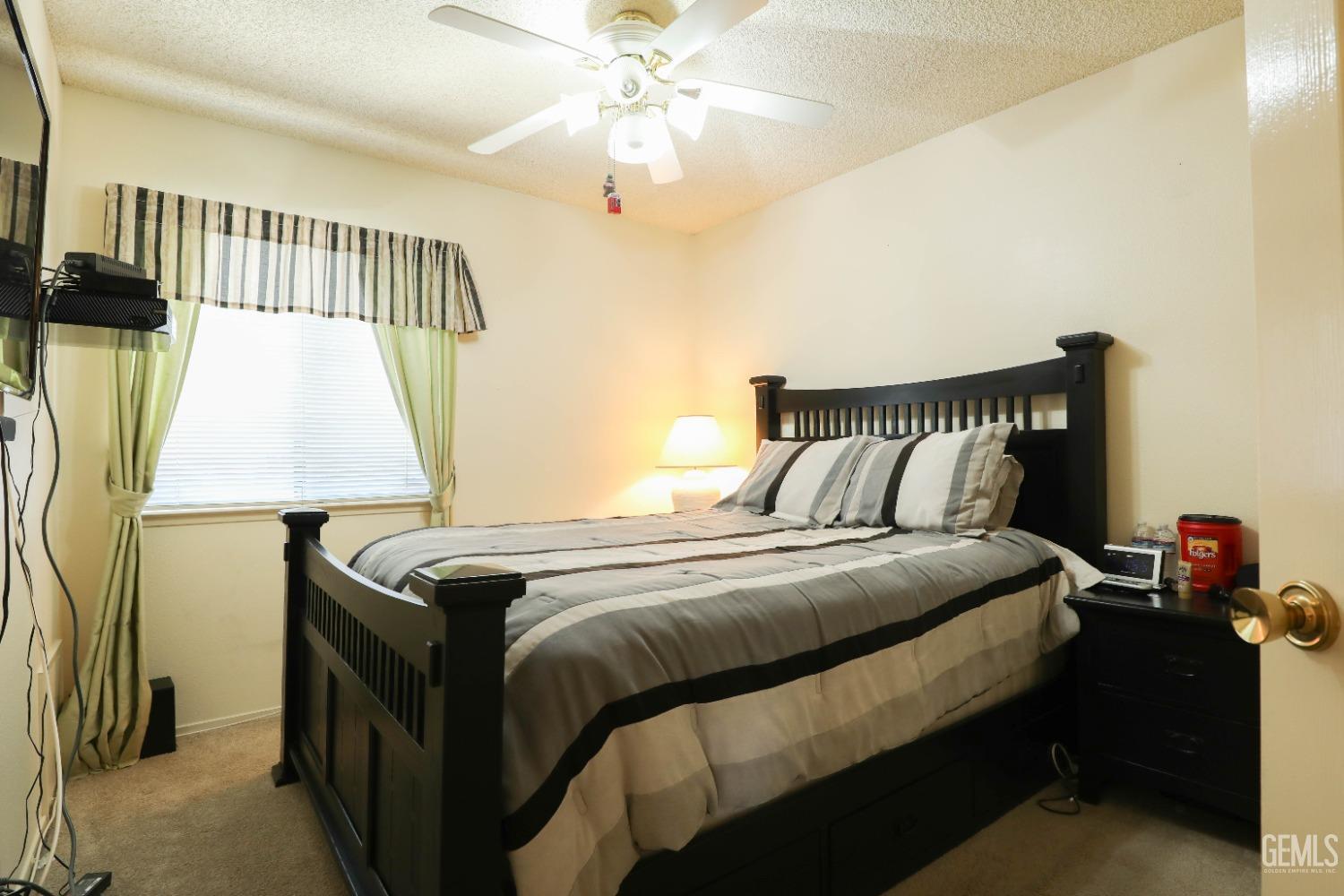 Undisclosed Address Bakersfield, CA 93313 - Photo 11 of 21 a bedroom with a bed and a window