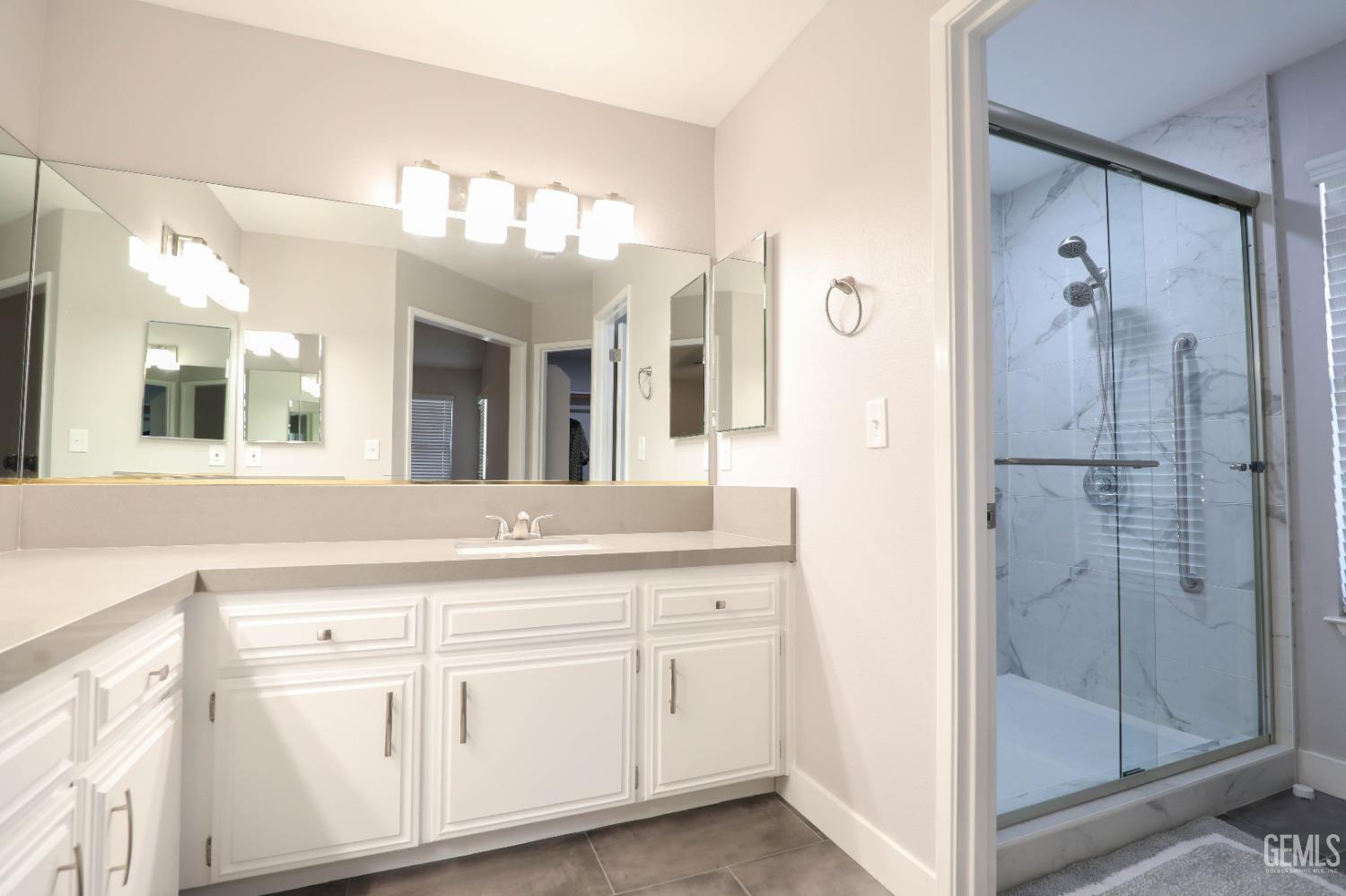 Undisclosed Address Bakersfield, CA 93313 - Photo 15 of 21 a bathroom with a double vanity sink mirror and shower