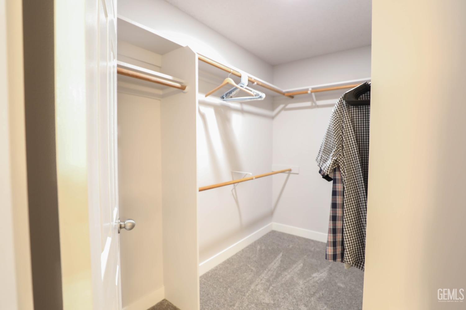 Undisclosed Address Bakersfield, CA 93313 - Photo 17 of 21 a view of walk in closet with empty racks