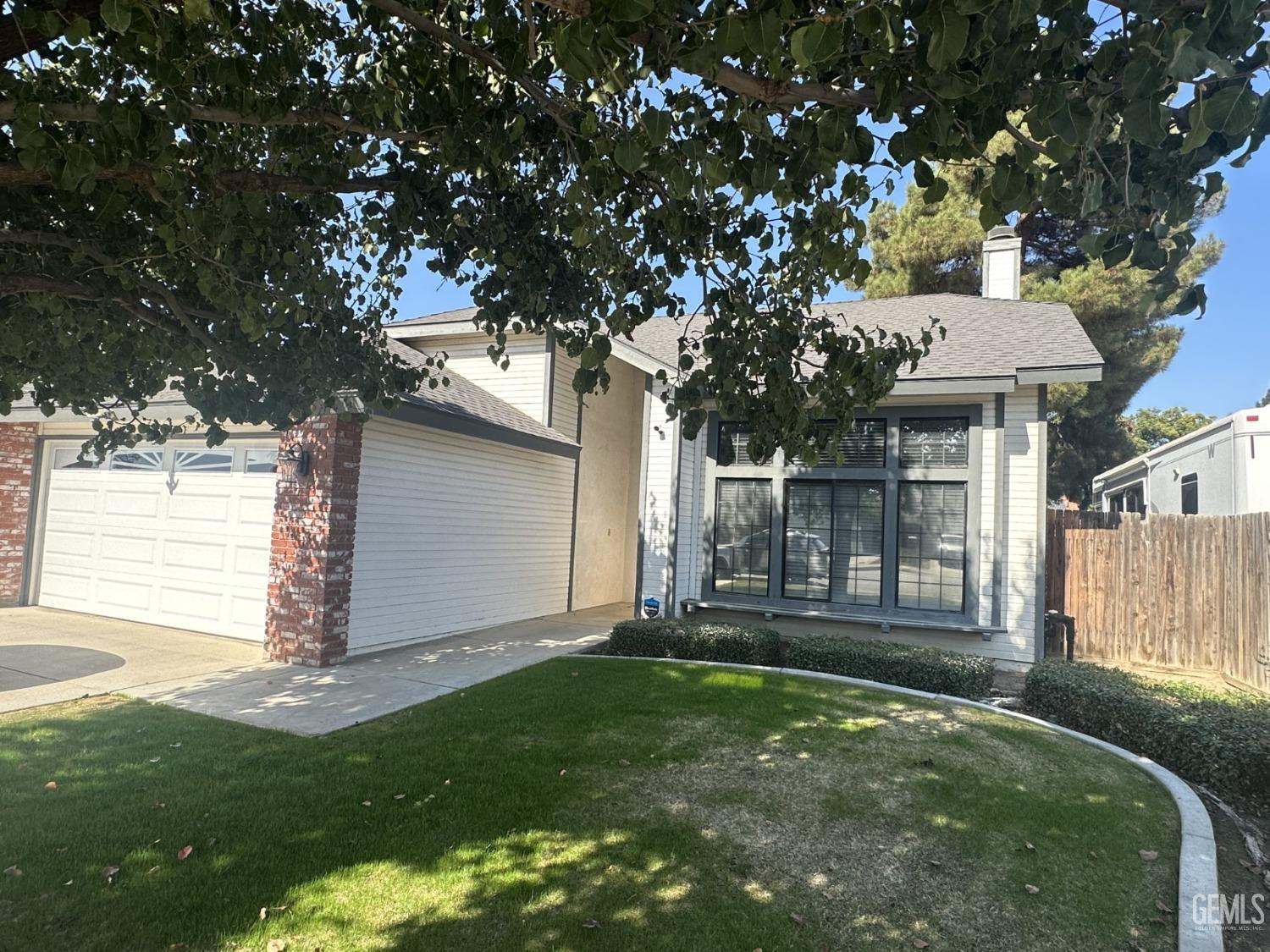Undisclosed Address Bakersfield, CA 93313 - Photo 2 of 21 a front view of a house with a yard