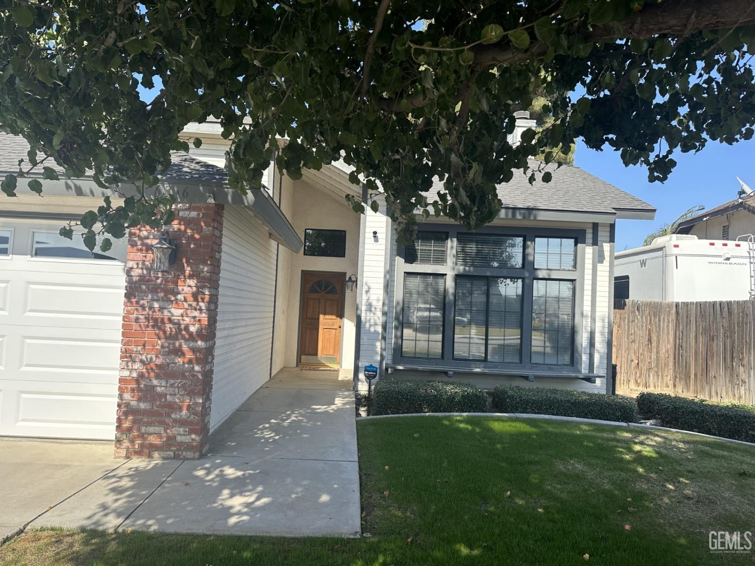 Undisclosed Address Bakersfield, CA 93313 - Photo 3 of 21 a front view of a house with a yard