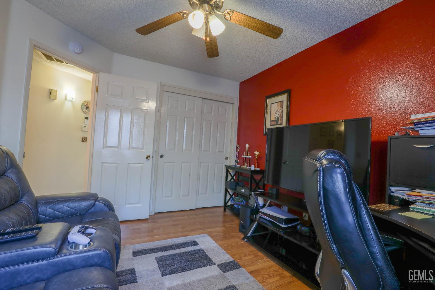 Undisclosed Address Bakersfield, CA 93313 - Photo 9 of 21 a room with furniture and a flat screen tv