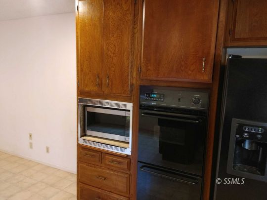 1014 Sherri Street Ridgecrest, CA 93555 - Photo 17 of 23 a kitchen with granite countertop cabinets and steel stainless steel appliances