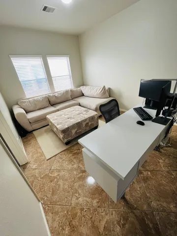 a living room with couches and flat screen tv