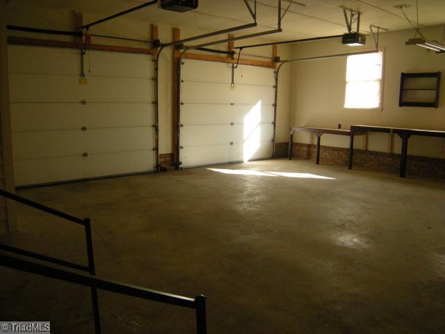 1796 Sandy Ridge Road Kernersville, NC 27284 - Photo 9 of 10 Parking Lot/Garage. Attached, oversized garage with garage door openers with plenty of space for a workshop