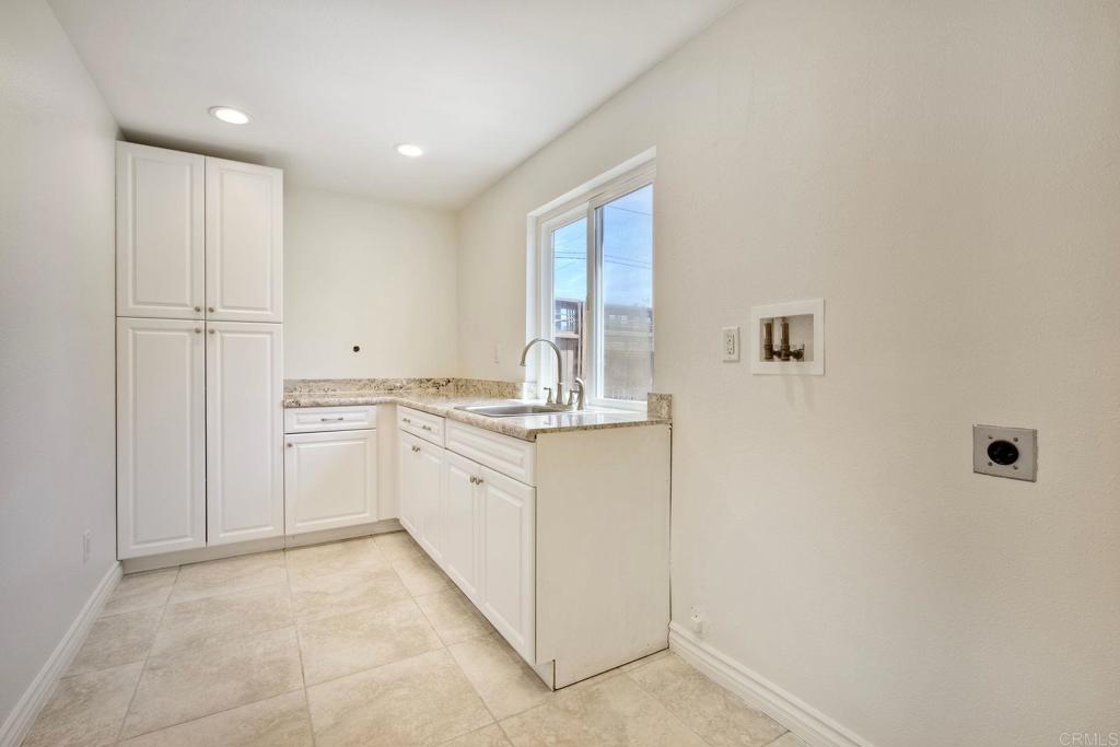 13815 Hilldale Road Valley Center, CA 92082 - Photo 17 of 50 a kitchen with granite countertop white cabinets and white appliances