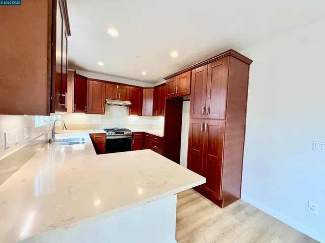 a kitchen with stainless steel appliances a refrigerator and a sink