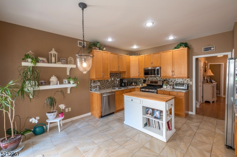 9 O'Connor Circle West Orange, NJ 07052 - Photo 12 of 29 a kitchen with stainless steel appliances granite countertop a refrigerator a sink dishwasher a stove and white cabinets with wooden floor