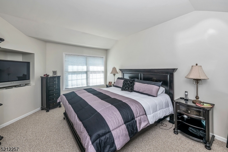 9 O'Connor Circle West Orange, NJ 07052 - Photo 15 of 29 a bedroom with a bed and a flat screen tv