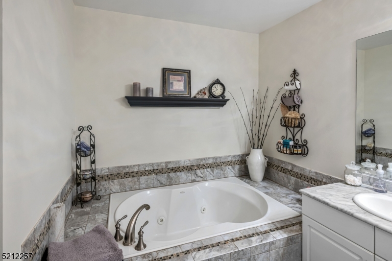 9 O'Connor Circle West Orange, NJ 07052 - Photo 19 of 29 a bathroom with a granite countertop sink and a mirror