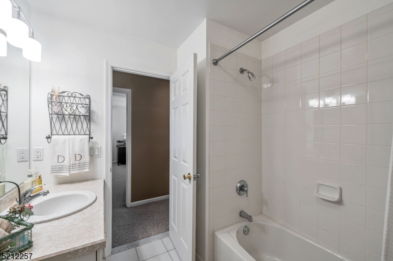 9 O'Connor Circle West Orange, NJ 07052 - Photo 26 of 29 a bathroom with a granite countertop sink a toilet and shower