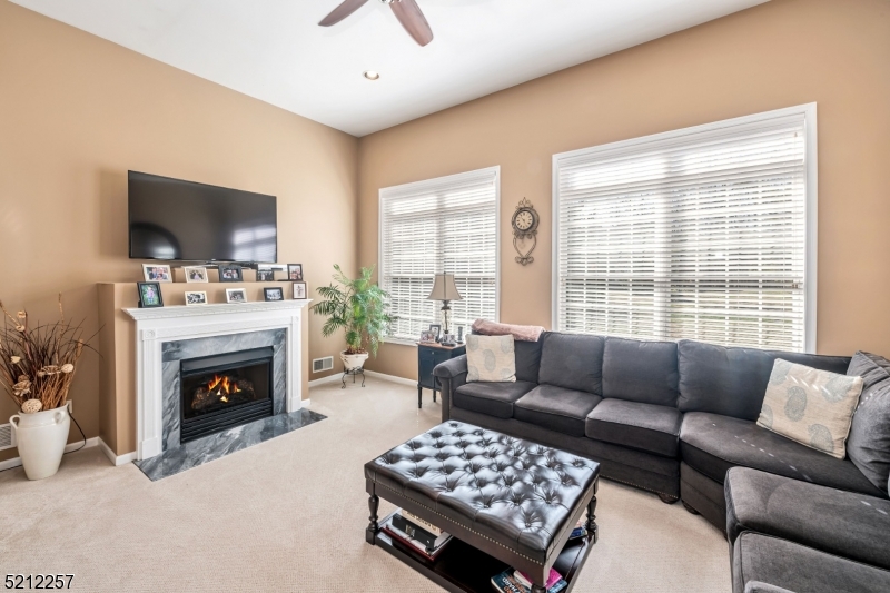 9 O'Connor Circle West Orange, NJ 07052 - Photo 10 of 29 a living room with furniture a flat screen tv and a fireplace