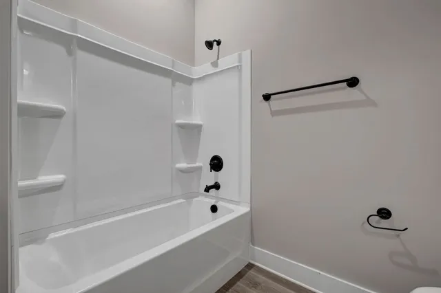 a bathroom with a bathtub and shower