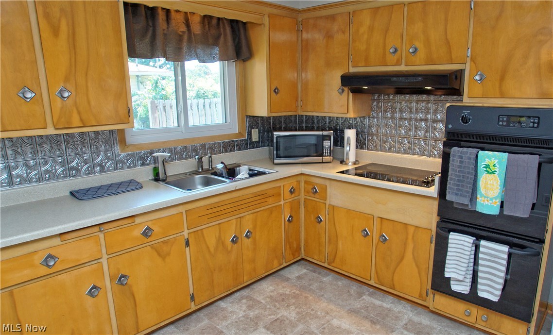 8601 Royal Ridge Drive Parma, OH 44129 - Photo 11 of 33 Large eat in kitchen with double oven and electric stove.